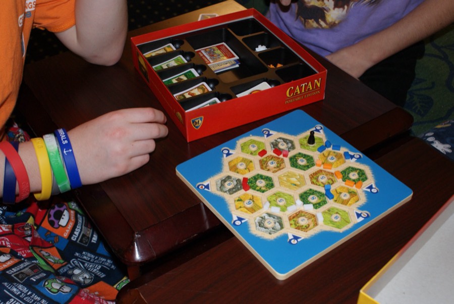 The travel edition of Settlers of Catan set up on a table